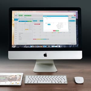 silver imac apple magic keyboard and magic mouse on wooden table