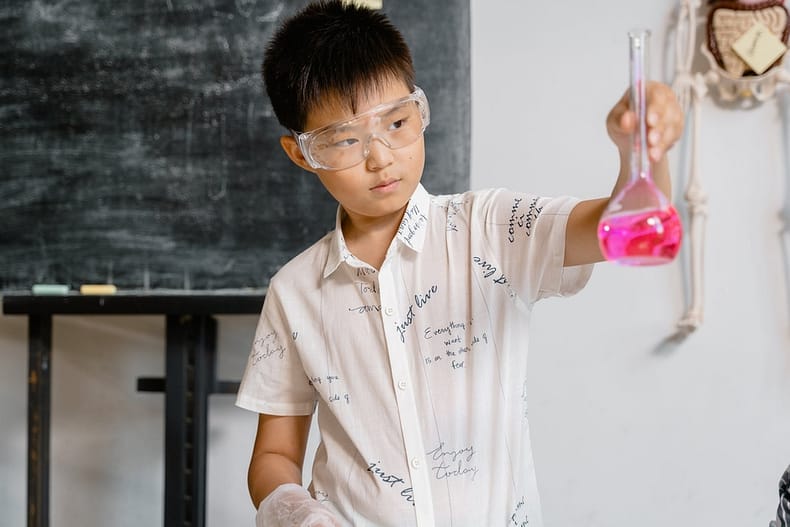 a smart boy doing a science experiment